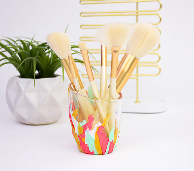 A Makeup Brush Jar painted white,pink,green, and orange