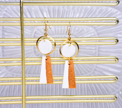 Gold earrings with white and tan detail