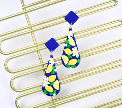 Glamor shot of blue earrings with lemons