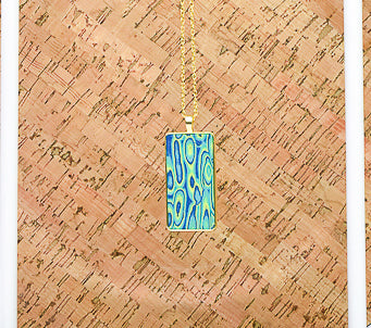 Shimmering Gold Pendant with blue, green, and yellow detail.